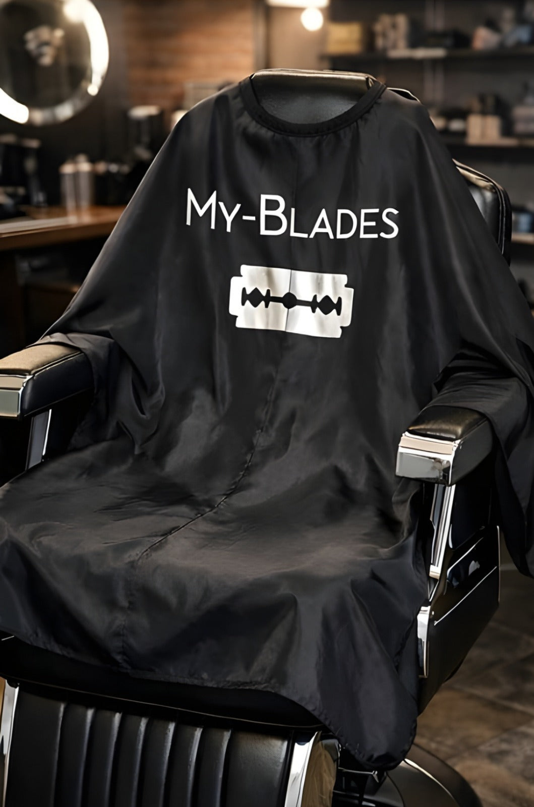My-Blades black professional barber cape with waterproof neckline in modern barbershop