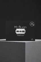 My-Blades Platinum 100 razor blades in black packaging with 80 percent recycled label displayed on a textured pedestal.