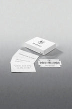 My-Blades razor blade box displayed with motivational quote cards and a single branded double-edge blade on a modern gray surface.