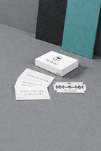 Minimal My-Blades razor blade packaging with branded blade and motivational quote cards on a clean light background.