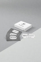 My-Blades Silver double-edge razor blade 10-pack with individual blade wrappers and single exposed blade displayed on light minimalist background.