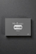 My-Blades Silver Professional 100 razor blades with box and single blade displayed upright on a reflective gray surface.