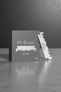 My-Blades Silver Professional 100 razor blades with box and single blade displayed upright on a reflective gray surface.