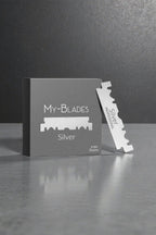 My-Blades Silver Professional 100 razor blades with box and single blade displayed upright on a reflective gray surface.